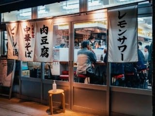 Authentic Japanese restaurant with noren curtains and COVID-19 safety measures.