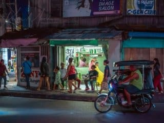Bustling Philippines street scene at dusk with lively local activities.