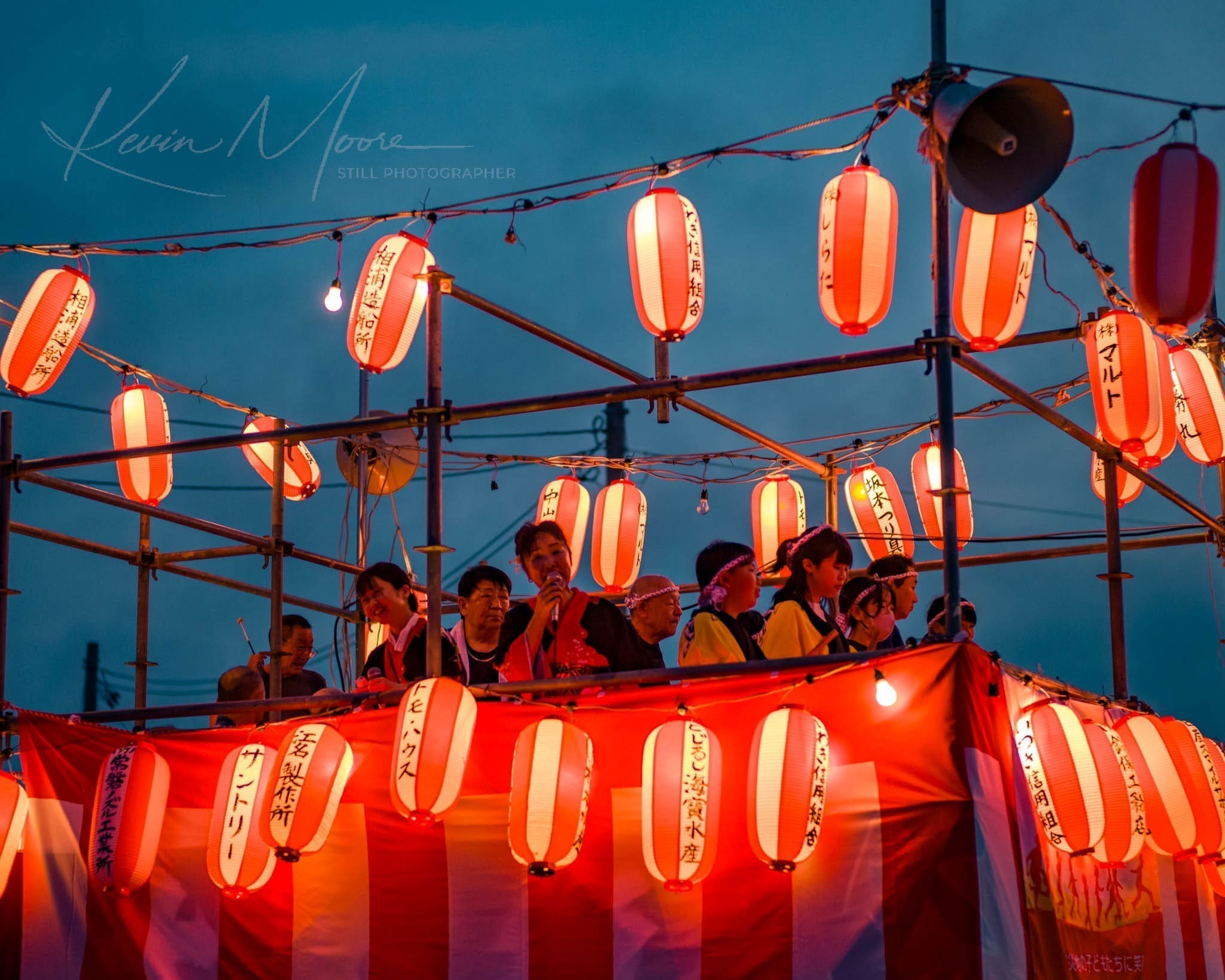 Vibrant Japanese festival with colorful lanterns and joyful crowd at dusk.