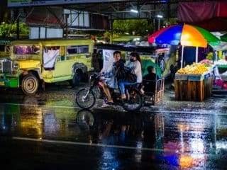 Rainy Resilience: An Evening in Motion Color photograph of rainy night scene in the Philippines