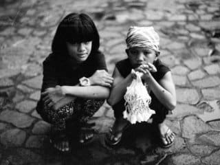 Siblings of Pampanga: A Monochrome Moment B&W Film photograph of children selling Sampaguita flowers in the Philippines