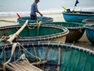 A fisherman in Da Nang Vietnam tends to his nets