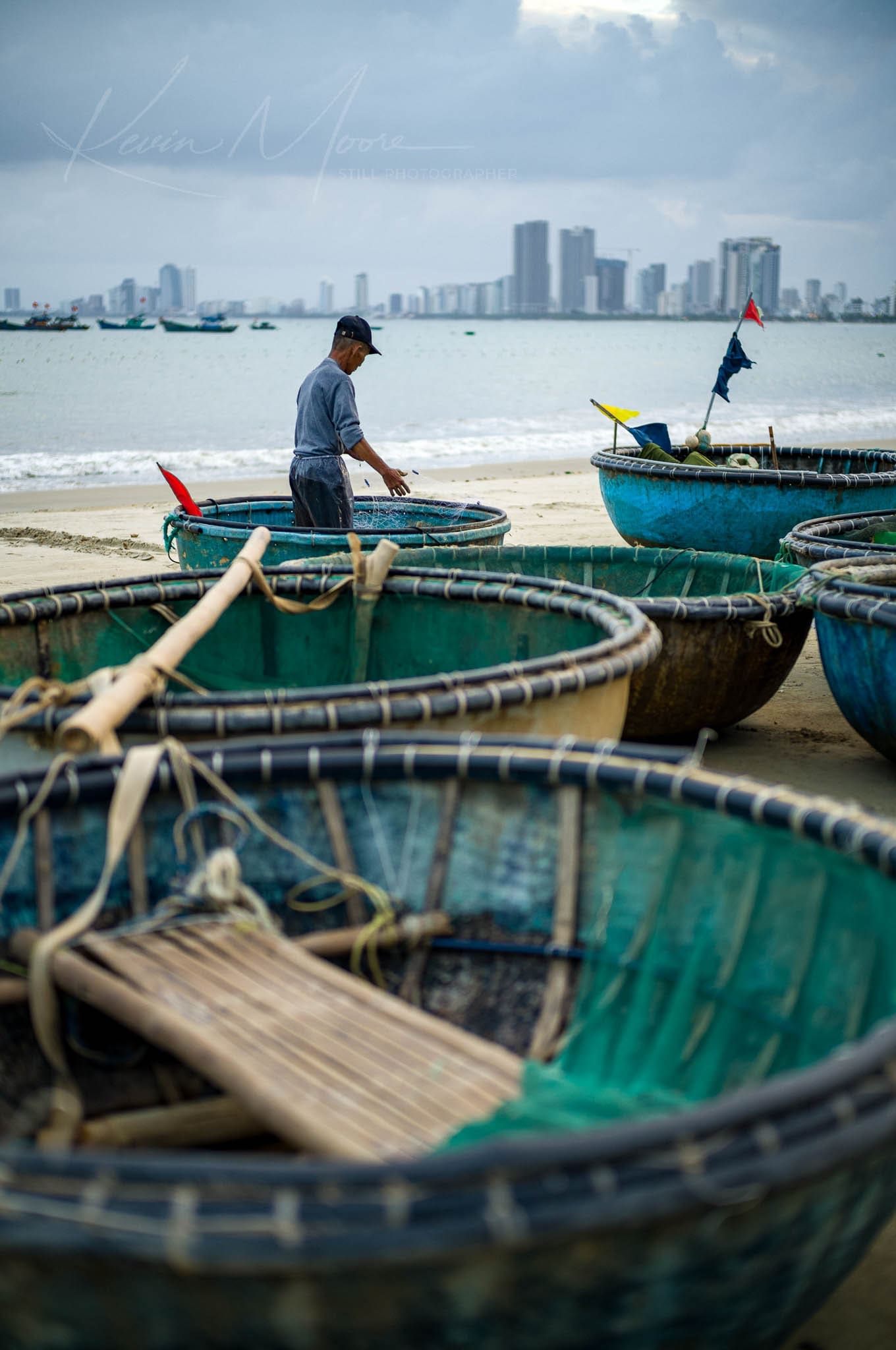 A fisherman in Da Nang Vietnam tends to his nets