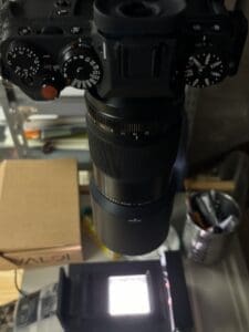 Professional DSLR camera with prime lens in a creative photography workspace.