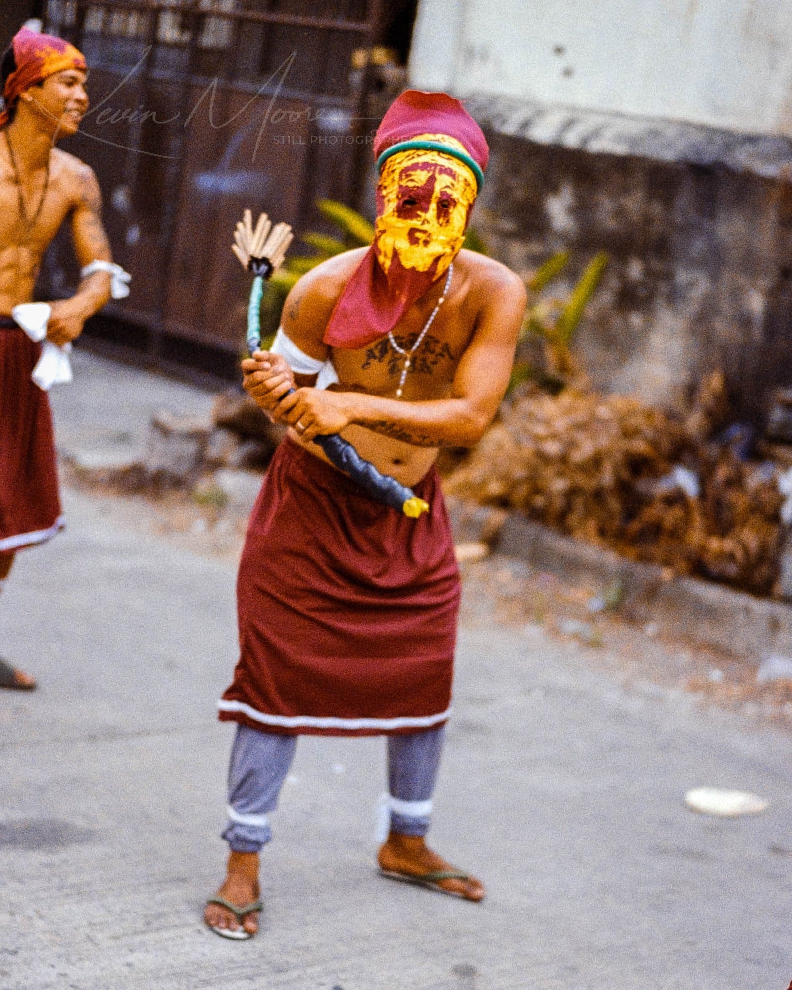 Masked dancer in colorful attire at Reenactment of Crucifixion