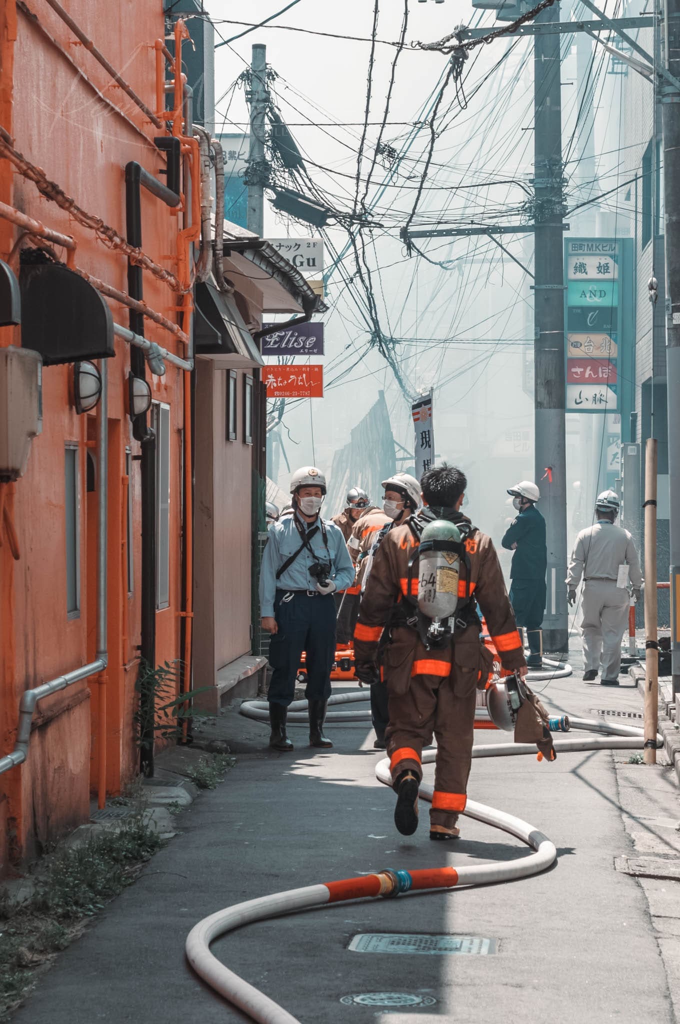 Firefighter in action in a Japan back alley.