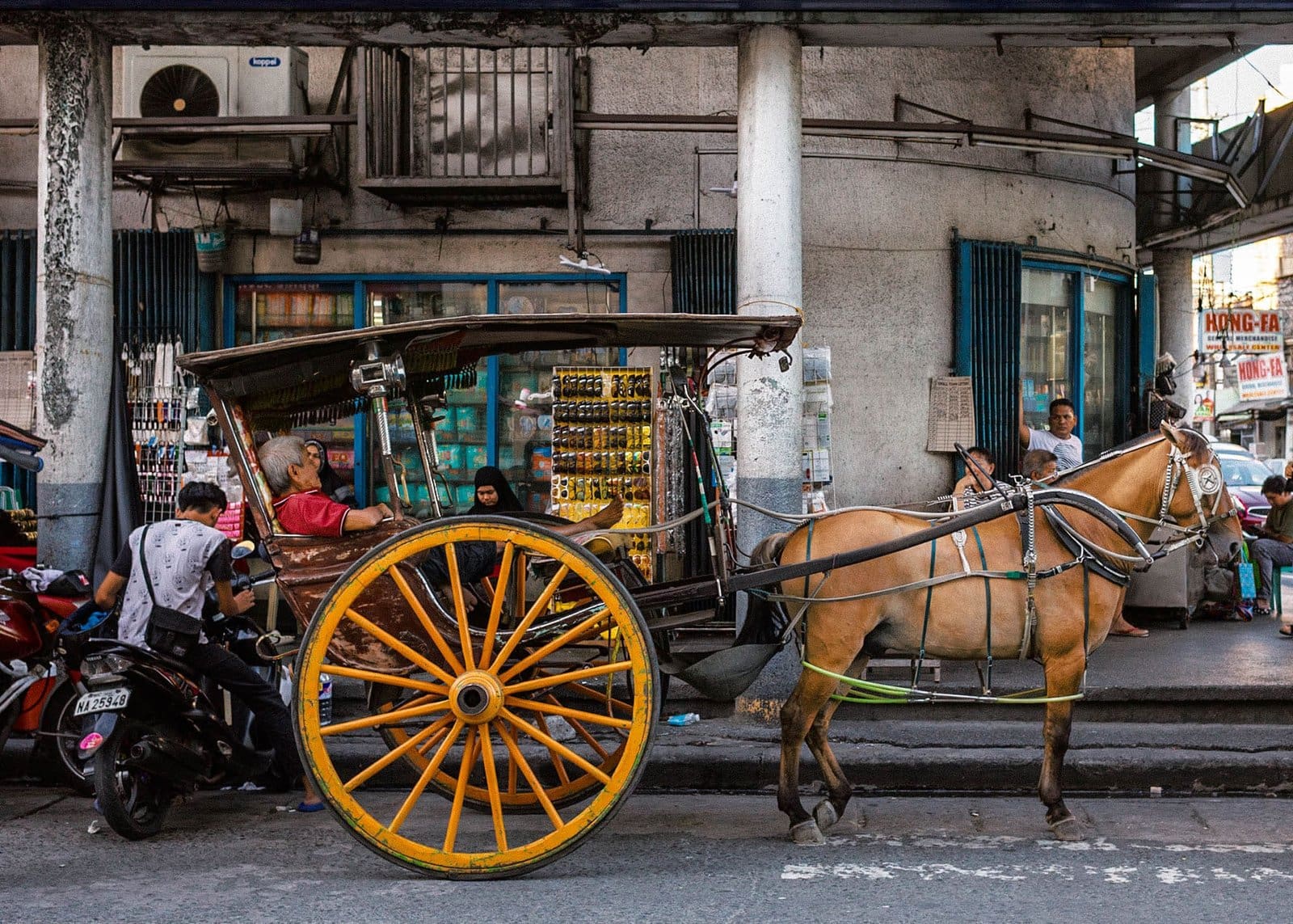 Philippines art print from Angeles City: a kalesa horse carriage and its sleeping driver at rest on the street
