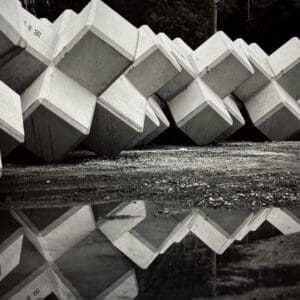 Concrete tetrapods reflected in a puddle, Ena village, Iwaki, Fukushima Japan, black and white silver gelatin print