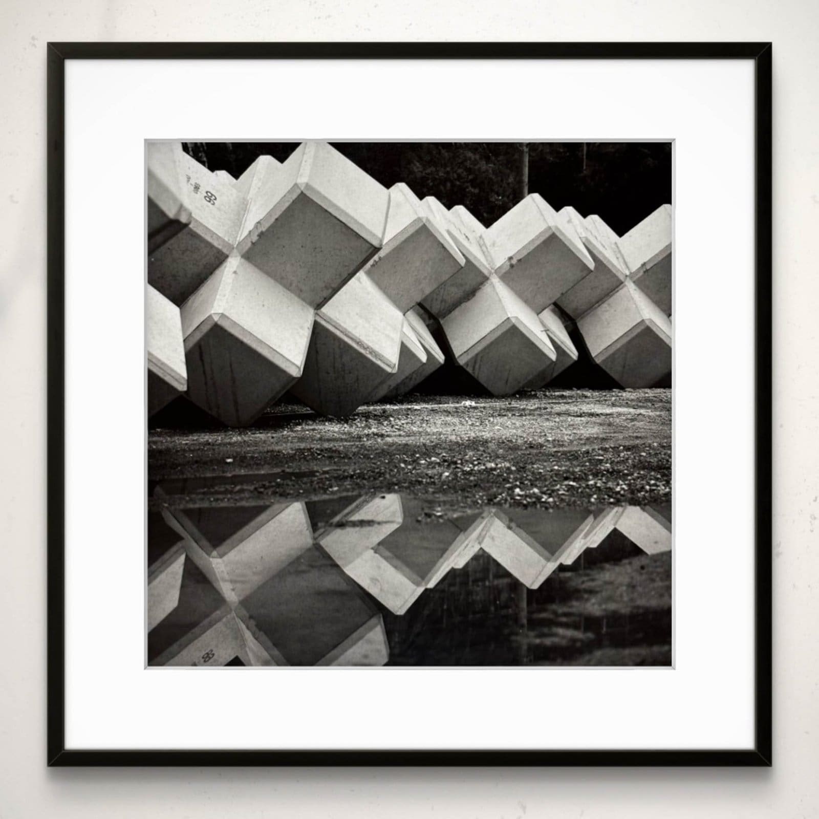 Concrete tetrapods reflected in a puddle, Ena village, Iwaki, Fukushima Japan, black and white silver gelatin framed print