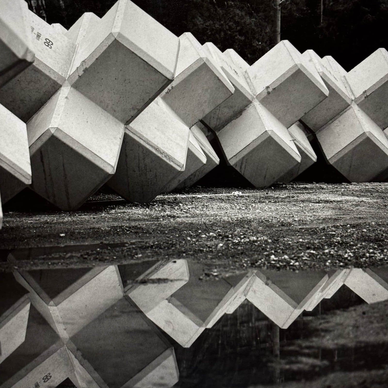 Concrete tetrapods reflected in a puddle, Ena village, Iwaki, Fukushima Japan, black and white silver gelatin print