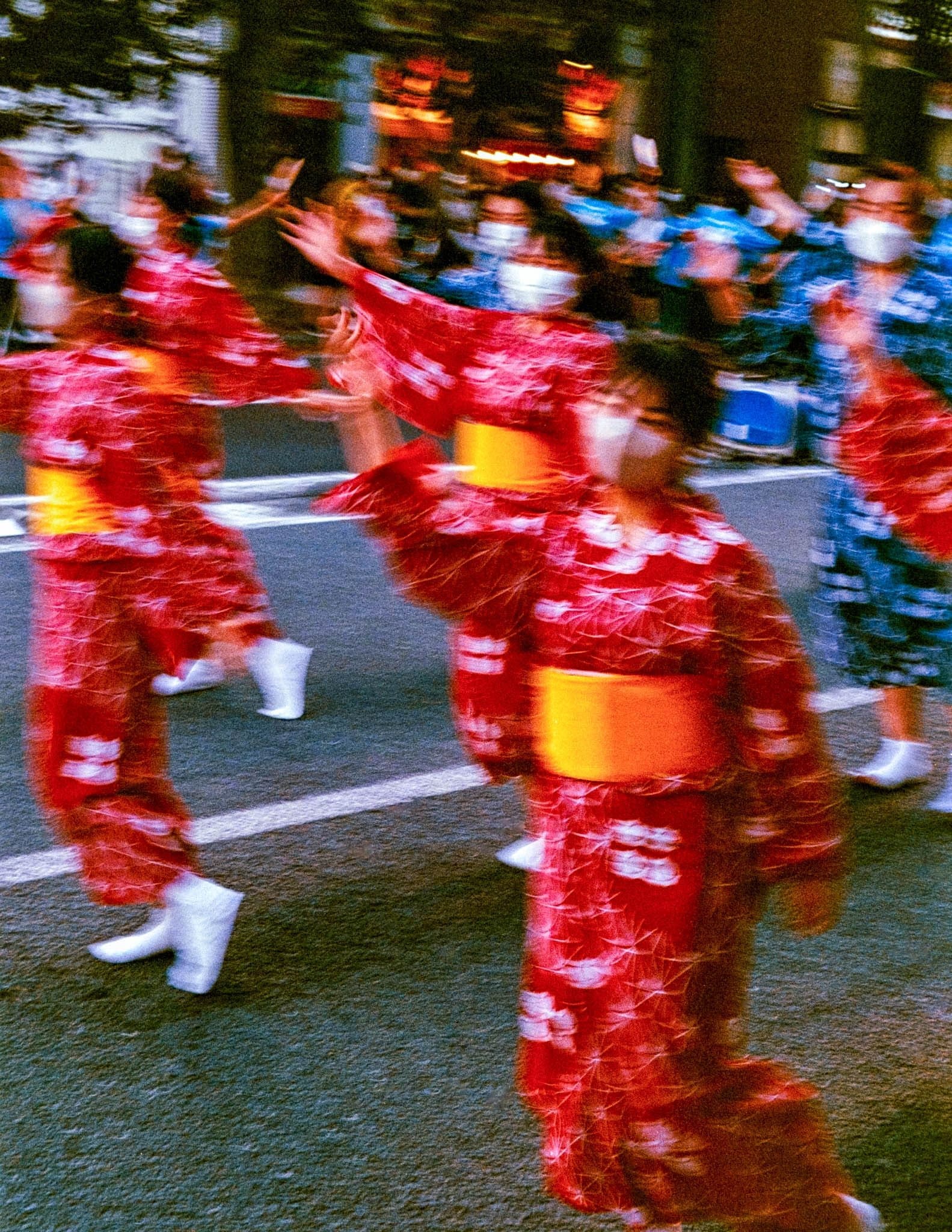 Japanese festival print: red-yukata dancers blurred in motion at a Bon Odori summer festival at night in Iwaki, Japan.