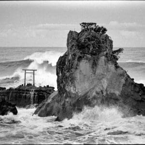 Japanese shrine print of the Bentenjima torii gate on a rocky outcrop as storm waves crash, Iwaki, Fukushima, Japan