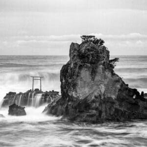 Torii gate wall art — the Bentenjima shrine gate standing in a stormy sea with long-exposure waves.